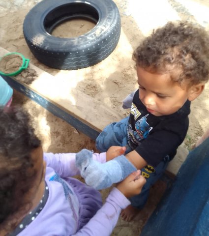 PK Harrison's big sister helps him with his socks